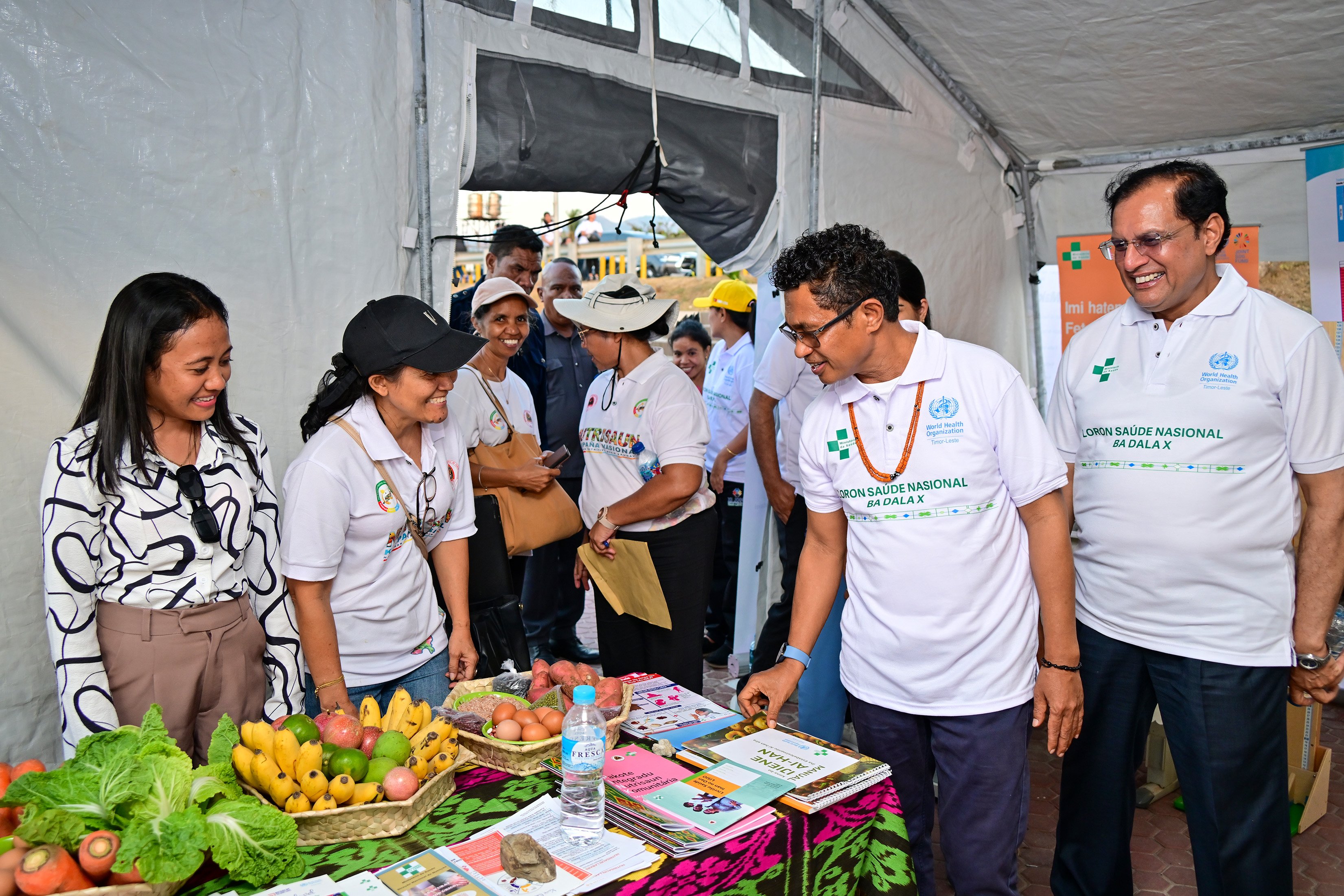 WHO Representative Dr Arvind Mathur accompanying Vice PM Mariano Assanami Sabino visiting health stall